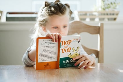 Girl Reading Dr Seuss- Photo by Josh Applegate on Unsplash-1