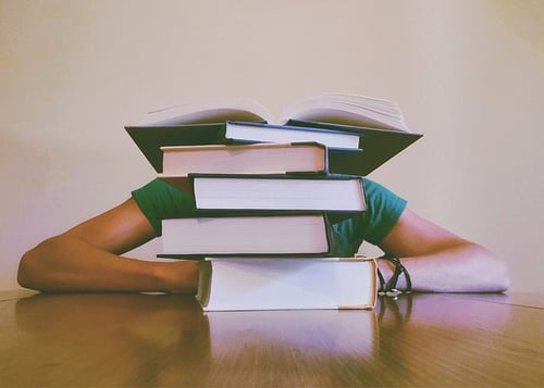 body_student_pile_of_books.jpg
