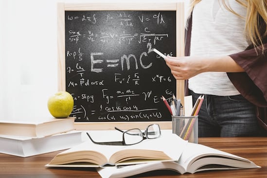 woman-illustrating-albert-einstein-formula-714698-1